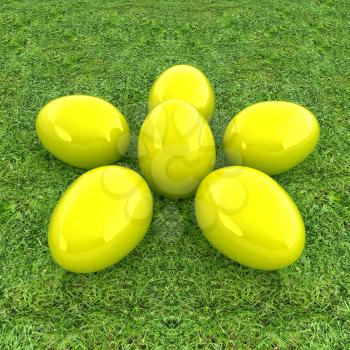 Yellow Easter eggs as a flower on a green grass