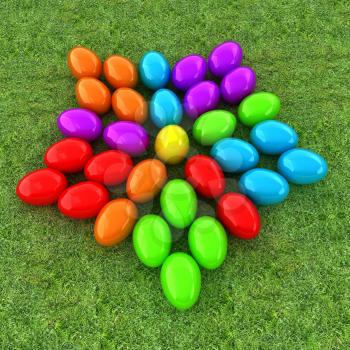 Colored Easter eggs as a flower on a green grass