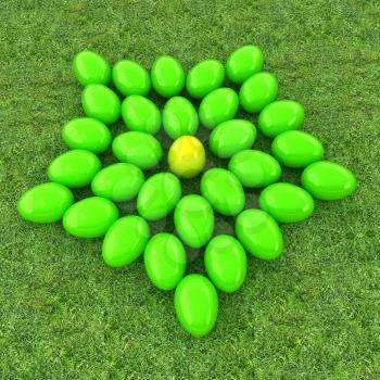 Colored Easter eggs as a flower on a green grass