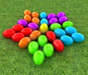 Colored Easter eggs as a flower on a green grass