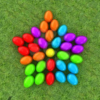 Colored Easter eggs as a flower on a green grass