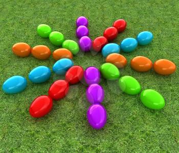 Colored Easter eggs as a flower on a green grass