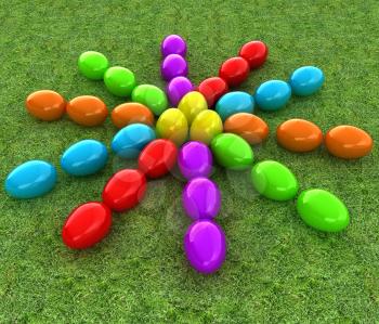 Colored Easter eggs as a flower on a green grass