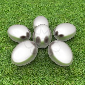 Metall Easter eggs as a flower on a green grass