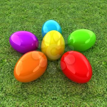 Colored Easter eggs as a flower on a green grass