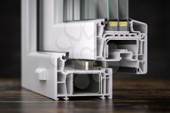 Cross section of plastic window profile PVC  slose up on the table. 3d illustration