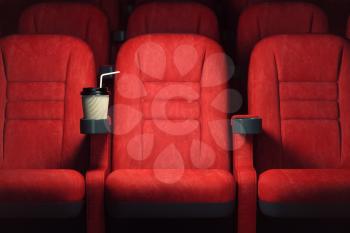 Cinema movie theater concept background. Red cinema seats and coffee or cola paper cup in empty theater. 3d illustration