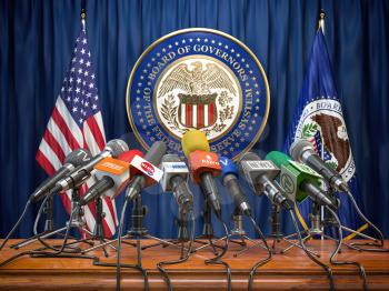 Federal Reserve System Fed of USA press conference concept. Microphones TV and radio channels with symbol and flag of US Federal Reserve. 3d illustration