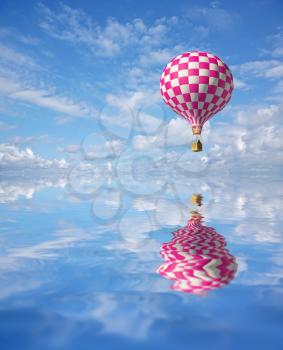 3d balloons in the blue sky and reflection in water