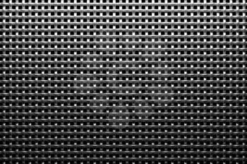 Braided wire steel grid with reflection on black background under the top straight light, abstract textured background