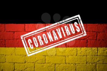 Flag of the Germany with original proportions. stamped of Coronavirus. brick wall texture. Corona virus concept. On the verge of a COVID-19 or 2019-nCoV Pandemic.