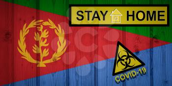 Flag of the Eritrea in original proportions. Quarantine and isolation - Stay at home. flag with biohazard symbol and inscription COVID-19.