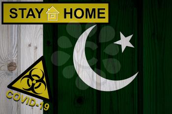 Flag of the Pakistan in original proportions. Quarantine and isolation - Stay at home. flag with biohazard symbol and inscription COVID-19.