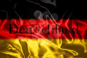 German flag blowing in the wind With Letters That Spell Deutschland Which Means Germany