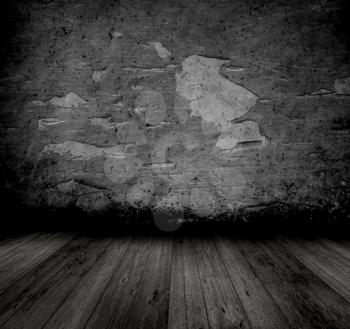 Grunge style image of an old interior with peeling walll and wooden floor