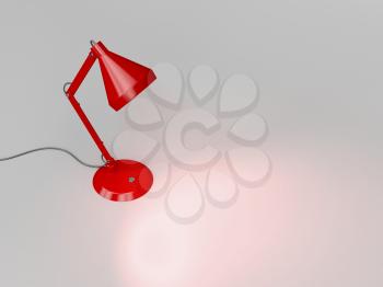 Red desk lamp illuminates the gray background 