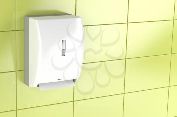 Automatic paper towel dispenser on green tiled wall 