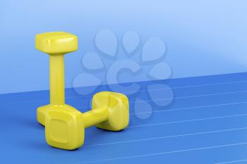 Two yellow dumbbells on shiny blue floor