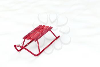 Metal red sledge in the snow 
