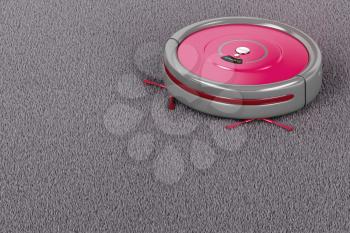 Cleaning the carpet with robotic vacuum cleaner 