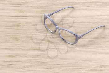 Female eyeglasses on wooden table 