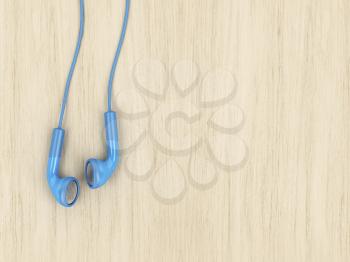 Blue wired earphones on wood background, copy space