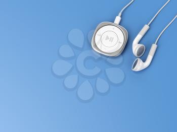 Portable music player and wired earphones on blue background, top view