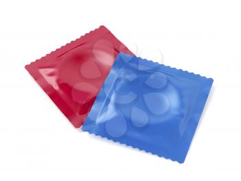 Two condoms on white background