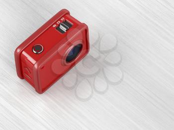 Red action camera on wooden table, 3D illustration