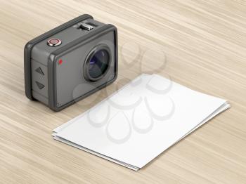 Digital camera and blank photos on the wood table
