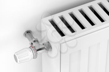 Close-up of white heating radiator with thermostat valve
