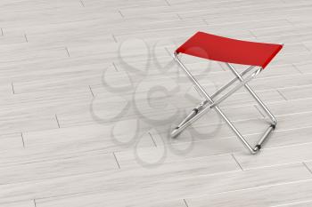 Red folding stool on wooden floor, 3D illustration
