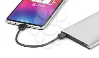 Smartphone charging with silver power bank, close-up