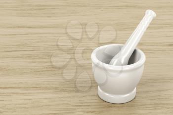 White mortar and pestle on wood table