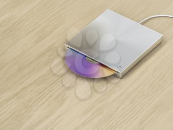 Silver optical disc drive on wood background