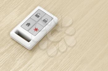 Remote control for home alarm or car on wood table