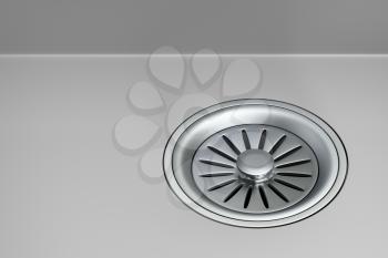 Stainless steel sink strainer with stopper installed on gray sink