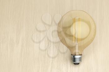 Decorative LED bulb on wooden desk
