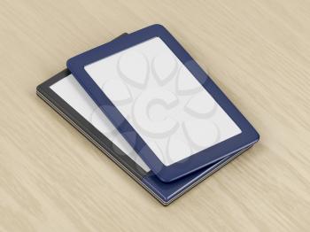 Two tablets or e-book readers with different designs and blank displays on wooden desk