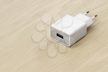 Smartphone, tablet or other electronic device charger with USB port on the wooden table