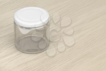 Empty glass jar on a wooden table