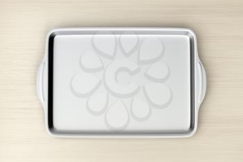 Stainless steel baking pan on wood table, top view