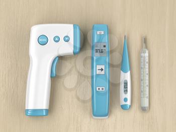 Different types of medical thermometers on wood table, top view