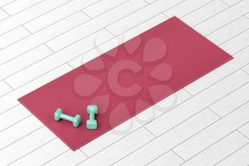 Two small dumbbells and rubber fitness mat on wood floor