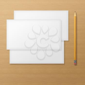 Set of blank envelopes with yellow pencil on wooden background. With soft shadows. 