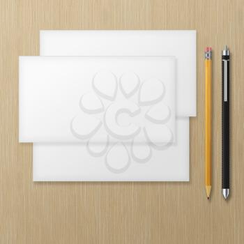 Set of blank envelopes with yellow pencil and pen on wooden background. With soft shadows. 