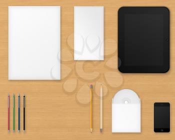 Office supplies for designers presentations and portfolios on wooden background. Above view.