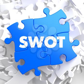SWOT  Written on Blue Puzzle Pieces. Business Concept.