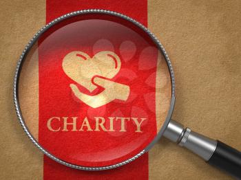 Charity Concept: Magnifying Glass with Icon of Heart in the Hand and Word Charity on Old Paper with Red Vertical Line Background.