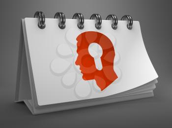 White Desktop Calendar with Red Icon of Profile of Head with a Keyhole on Gray Background. Psychological Concept.